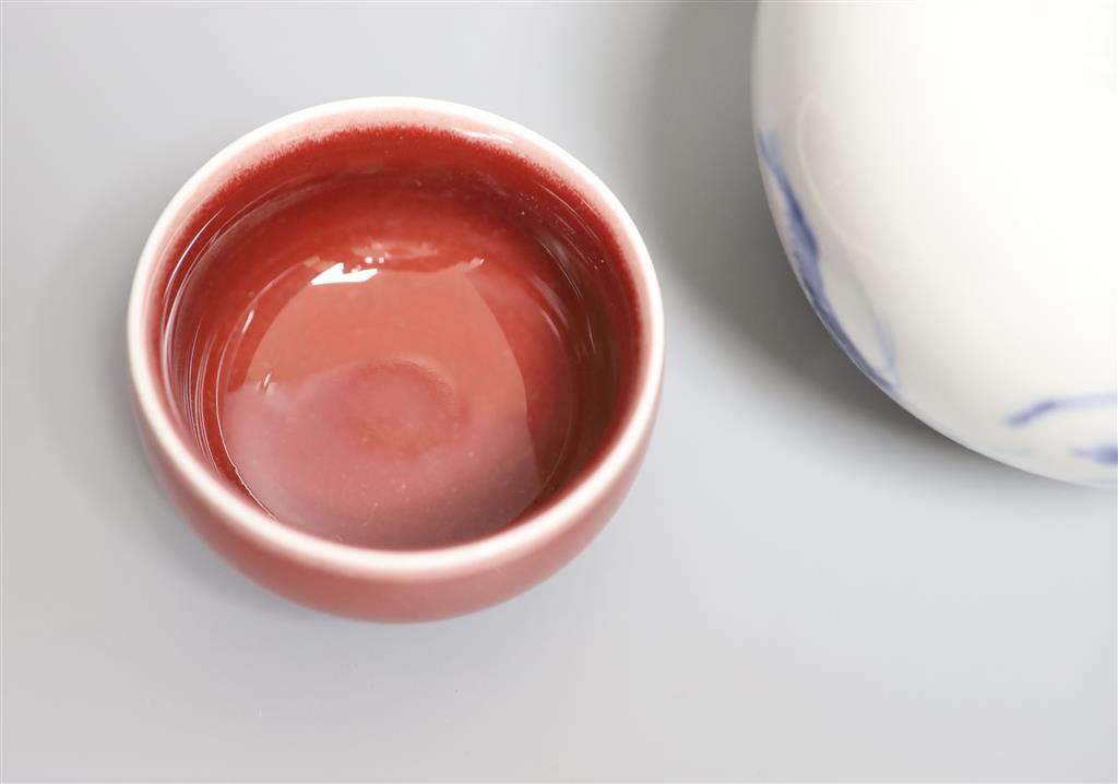 A Chinese blue and white water pot and two sang de boeuf glazed cups, tallest 9cm